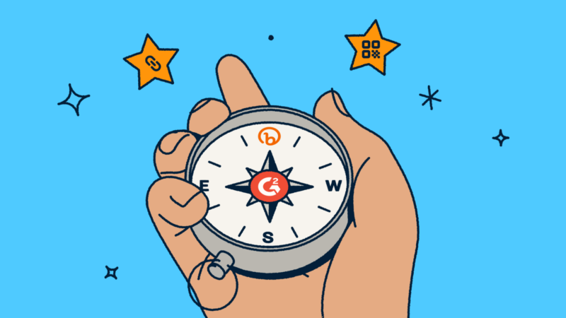 Person holding a compass with a G2 and Bitly logo within in.