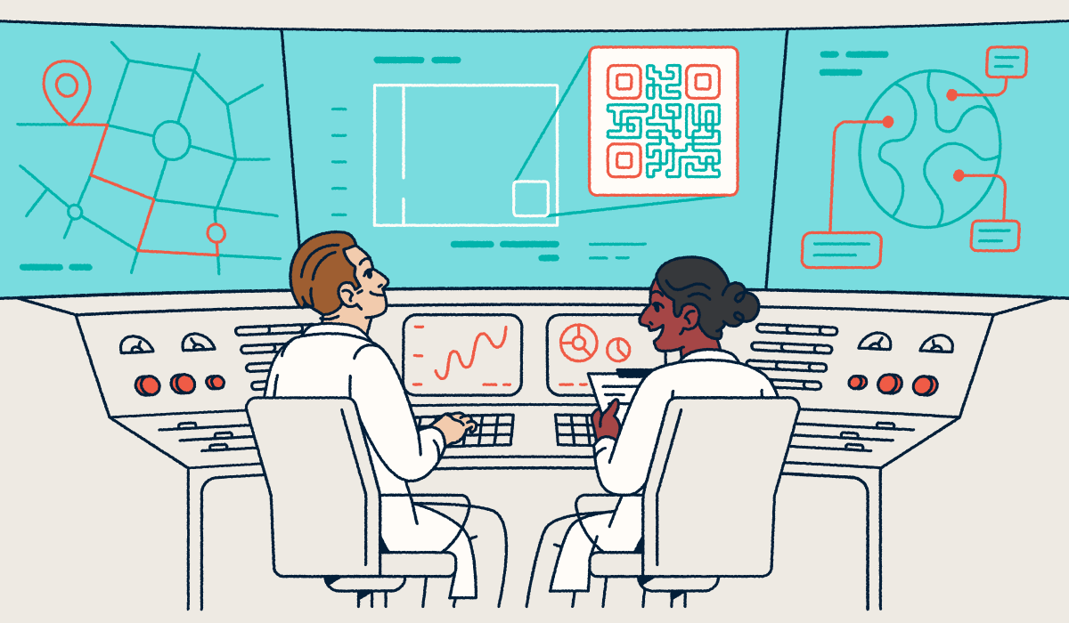 Two scientists sitting at a console looking at screens with QR Codes and graphs.