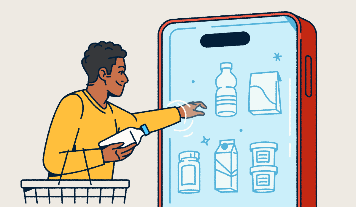 A person holding a shopping basket and selecting consumer packaged goods from a mobile "fridge."