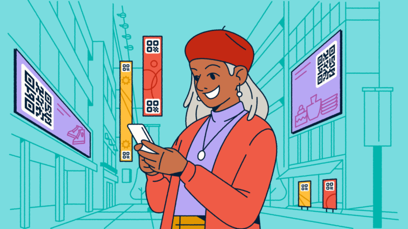 A woman standing in a city with digital advertisements featuring QR Codes around her. She's holding a smartphone in her hands.