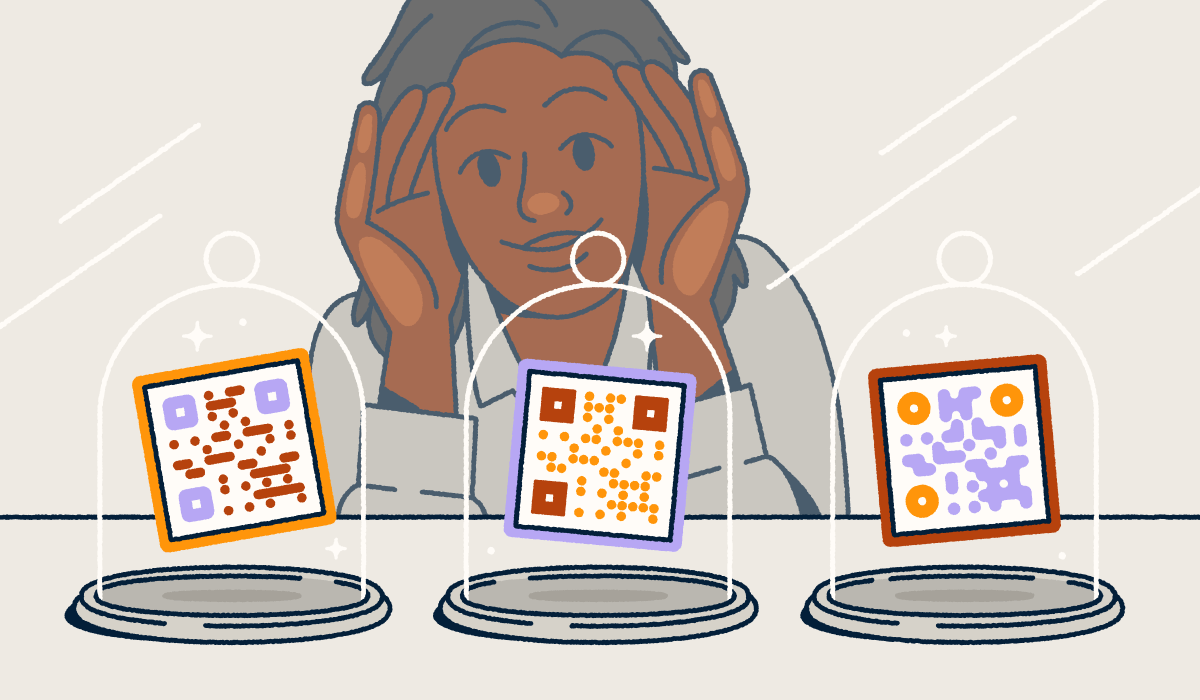 A person looking through a store-front window at three different QR codes on display in glass cloches.